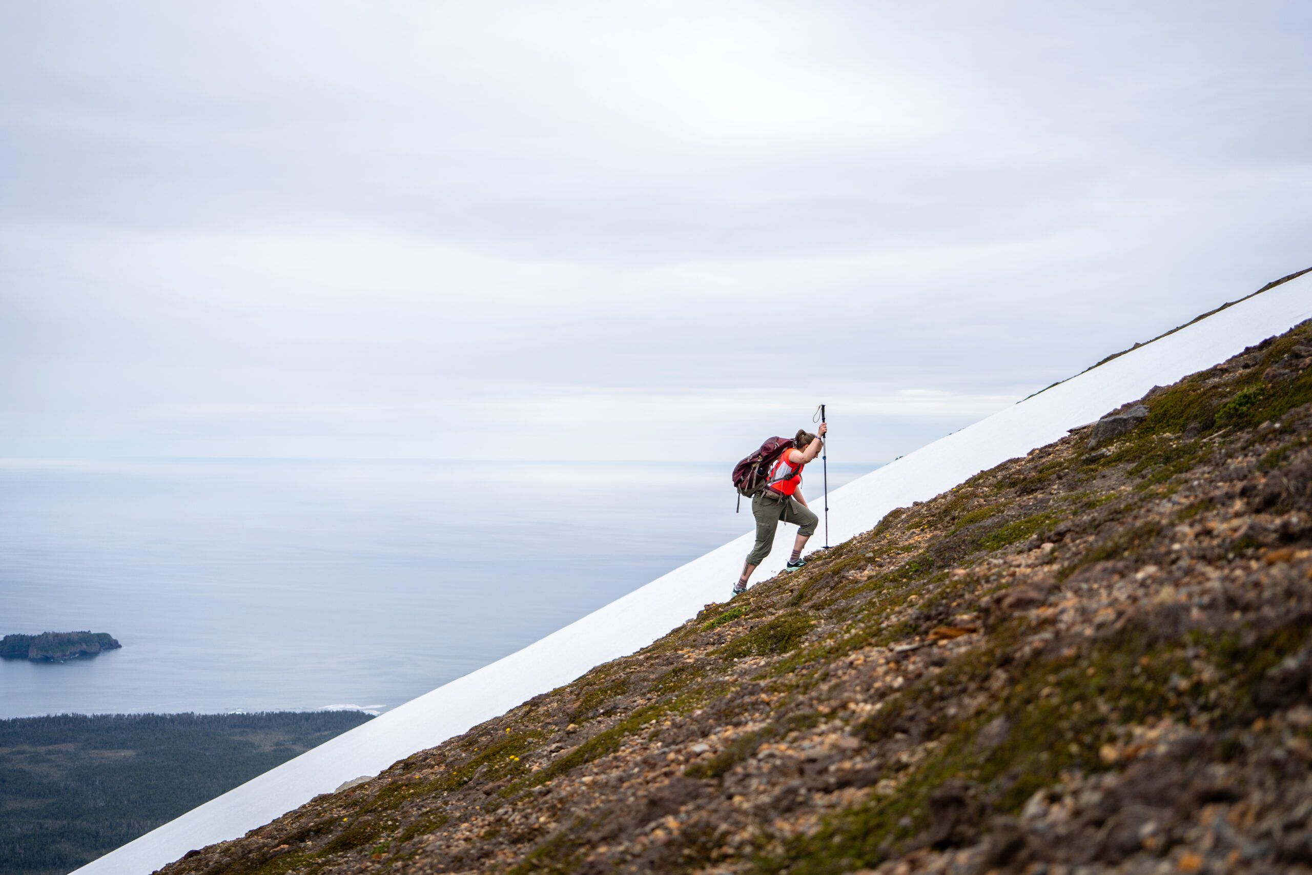A hiker climbs the last portion of the Mt. Edgecumbe trail, a very steep and volcanic hike to the summit.